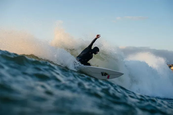 Erik surfing on a wave