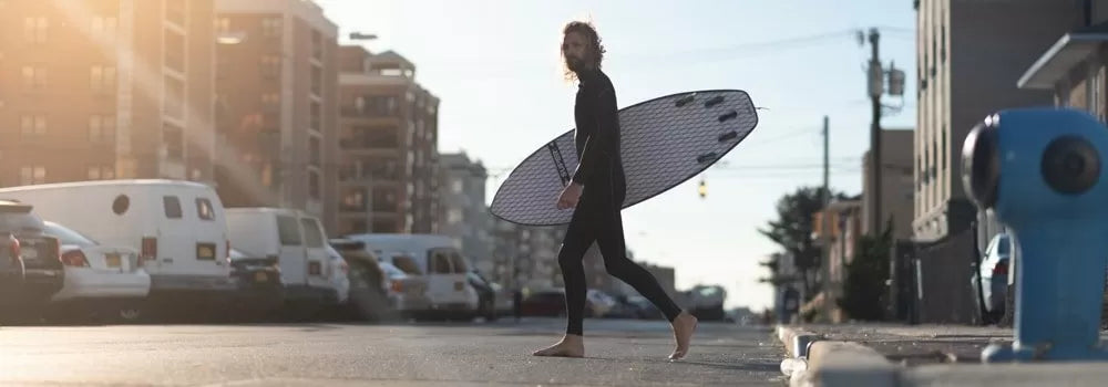 surfer in SRFACE wetsuit in urban city